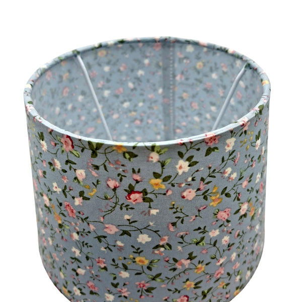 Hellblauer Lampenschirm mit floralen Motiven, ideal für einen bohemian-ländlichen Wohnstil. Verleiht jedem Raum Charme.